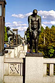 Oslo, Norway. Vigeland Park. Sculptures of the bridge, Boy standing in front of man 